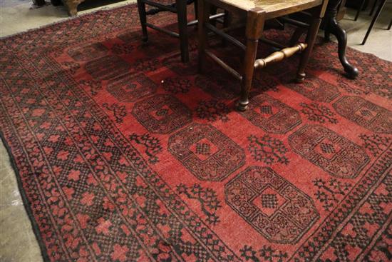 An Afghan burgundy ground carpet, 290 x 208cm